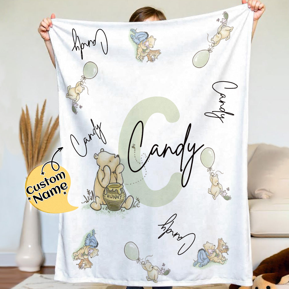 Top-down view of soft flannel Winnie the Pooh blanket with customised name.