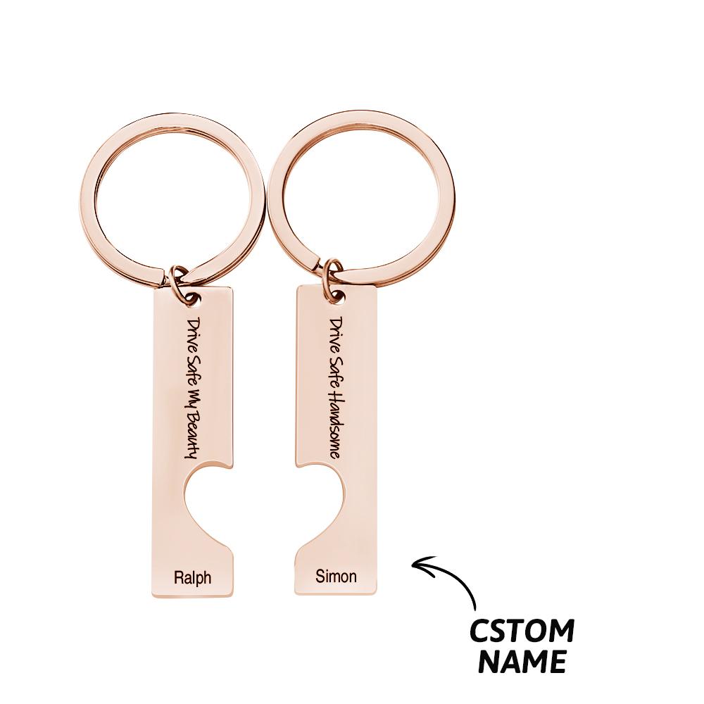 Close-up of engraved 'Drive Safe' motif and personalised text on a stainless steel couple keyring – custom engraving detail