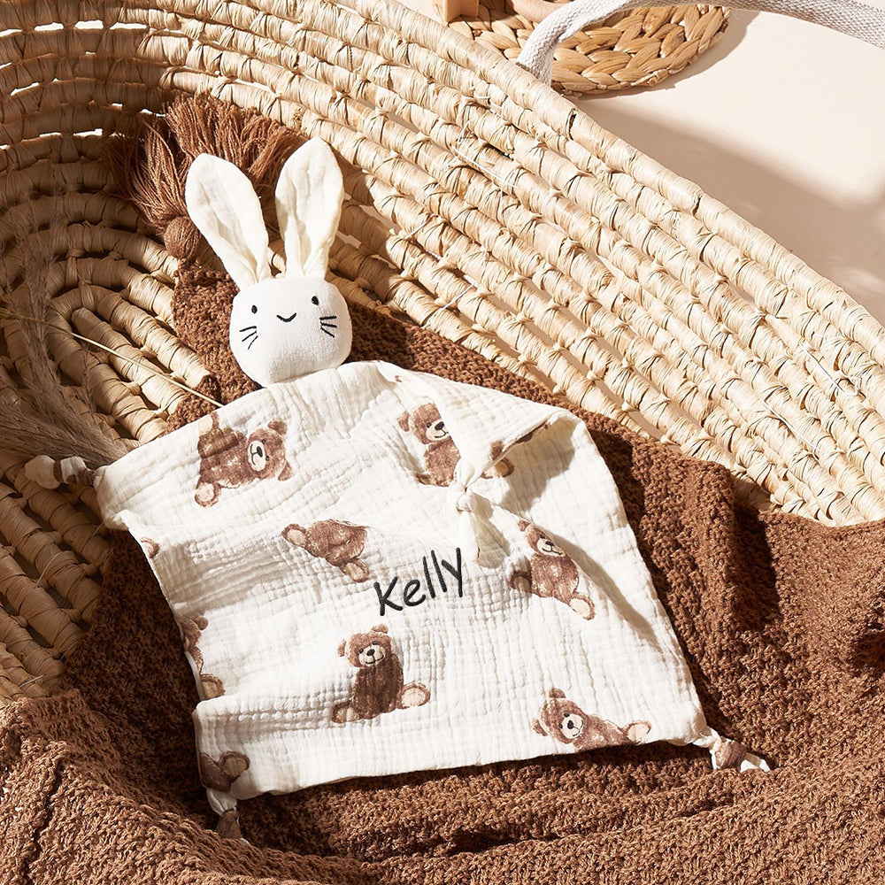 Close-up detail of embroidery and cotton texture on the baby comforter