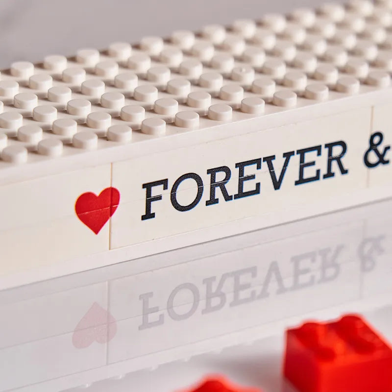 Couple assembling a custom 'I Love You' brick photo puzzle — perfect anniversary or Valentine's Day gift