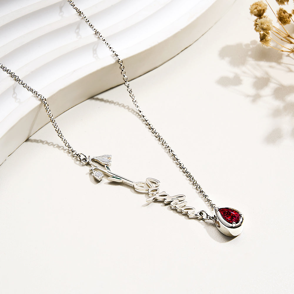 Close up of birthstone and floral charm with personalised name engraving on copper personalised necklace – birthstone jewellery for her