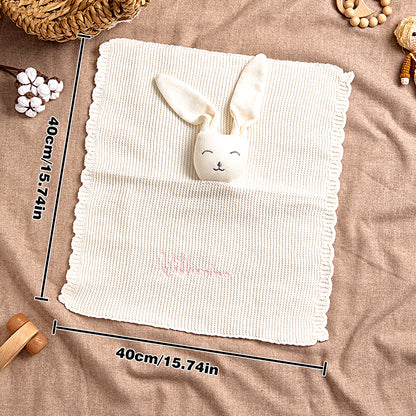 Lifestyle shot of the bunny towel in a nursery setting with cosy textures.