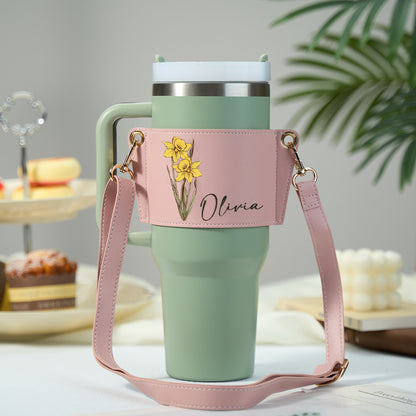 Adjustable PU leather strap and buckle detail on a personalised birth flower carrier for a 40oz Stanley tumbler