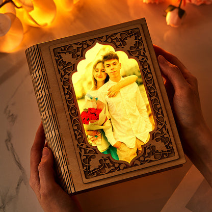 Close-up of personalised grimoire-shaped mirror photo frame (16.5cm x 20cm) showing crystal-clear acrylic reflection and photo