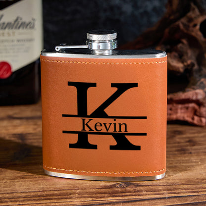Angled view of a 6oz personalised stainless steel whisky flask showing the screw-top cap and engraved initials on premium PU leather — perfect Father's Day or groomsmen gift