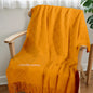The blanket spread in a nursery setting to illustrate its cosy feel for children’s rooms.
