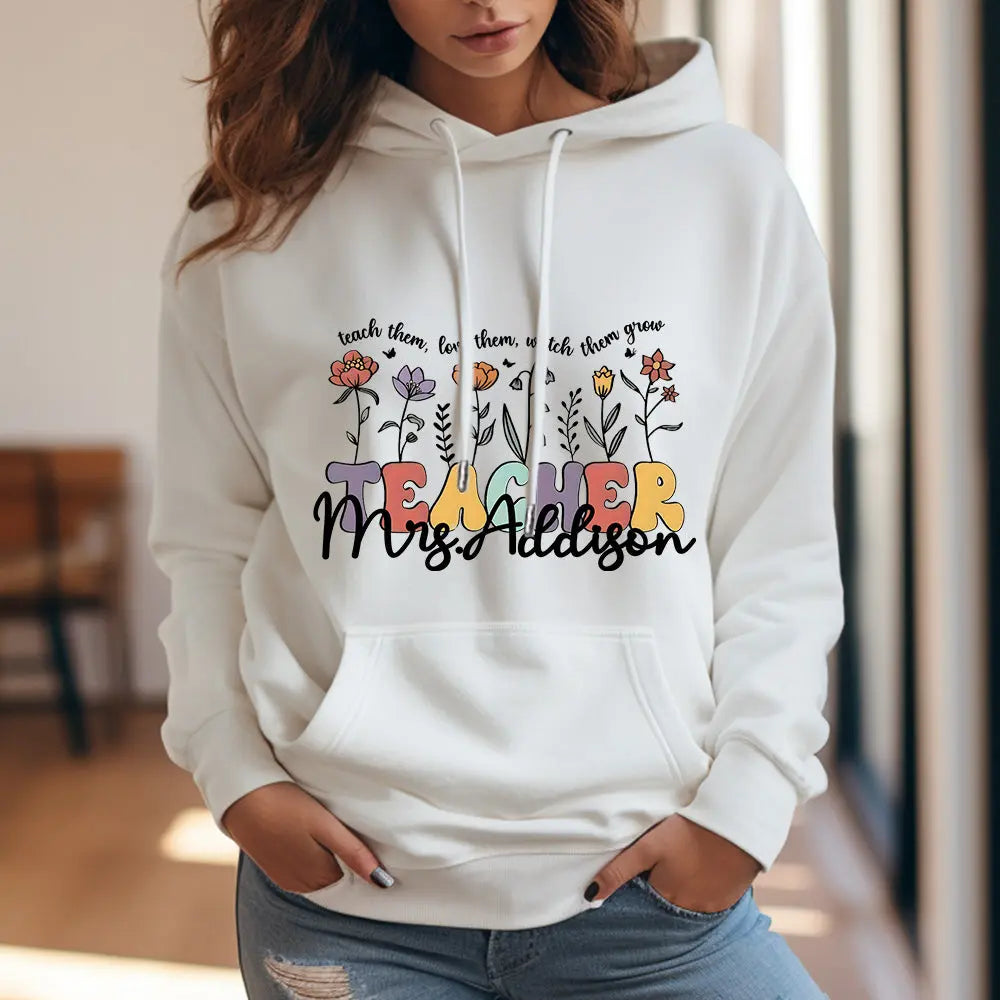 Back view highlighting the custom name above the wildflower design on this personalised teacher hoodie — excellent custom name hoodie for school staff