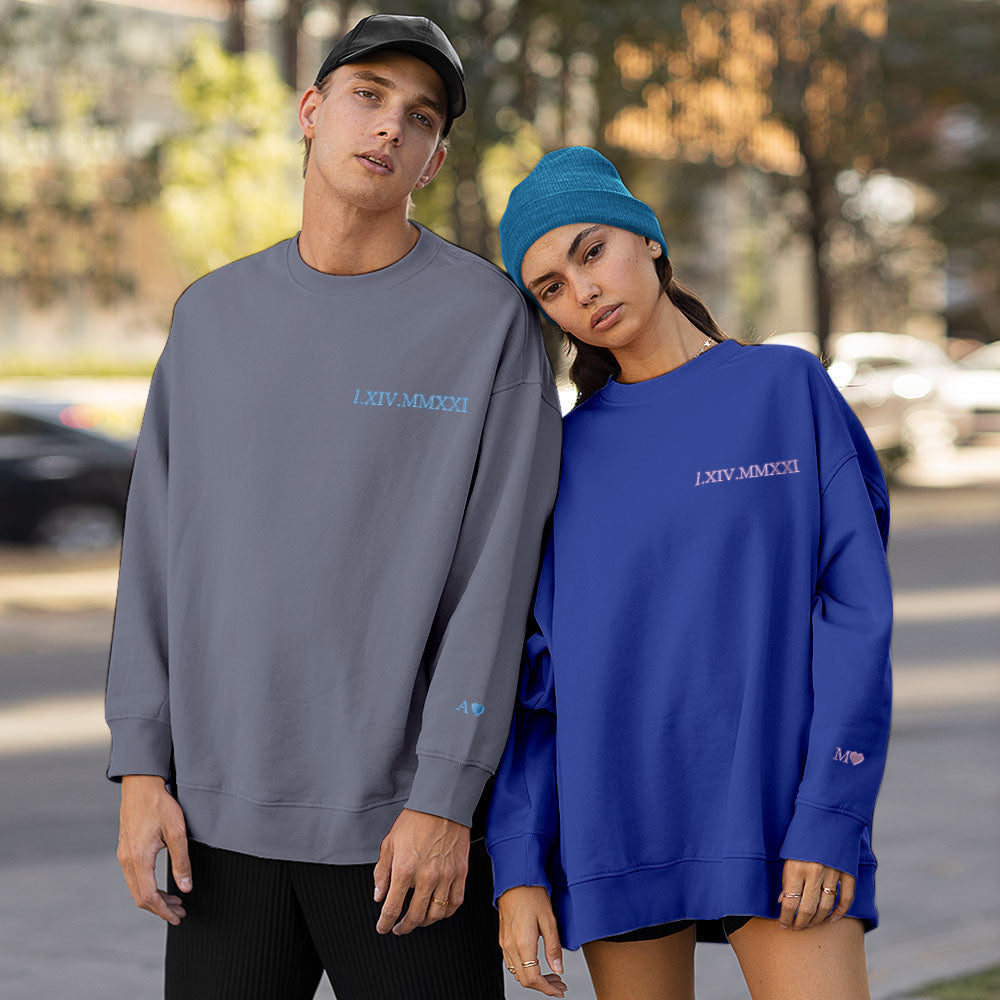 Teen couple styled in matching personalised embroidered hoodies demonstrating relaxed unisex fit and modern styling