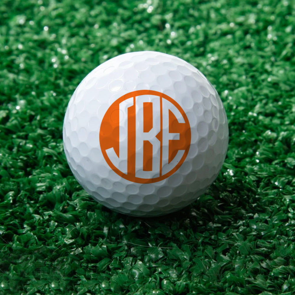 Personalised monogram golf balls in white showing custom initials, UV‑printed on durable rubber with wind‑tunnel dimples, ideal personalised golf gift for him