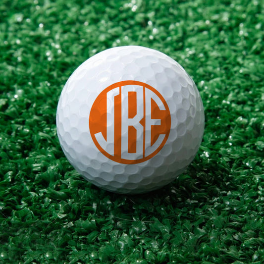Personalised monogram golf balls in white showing custom initials, UV‑printed on durable rubber with wind‑tunnel dimples, ideal personalised golf gift for him