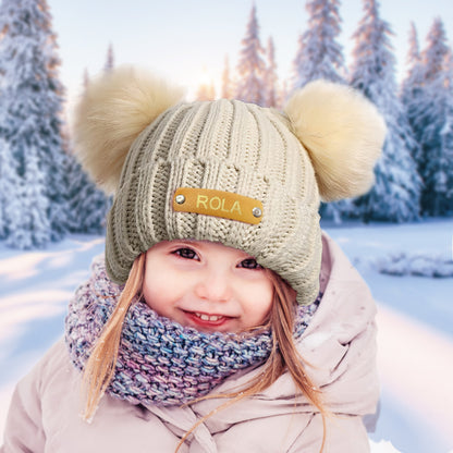 Close-up of stretchy acrylic knit and stitch detail on a personalised baby beanie with leather name patch