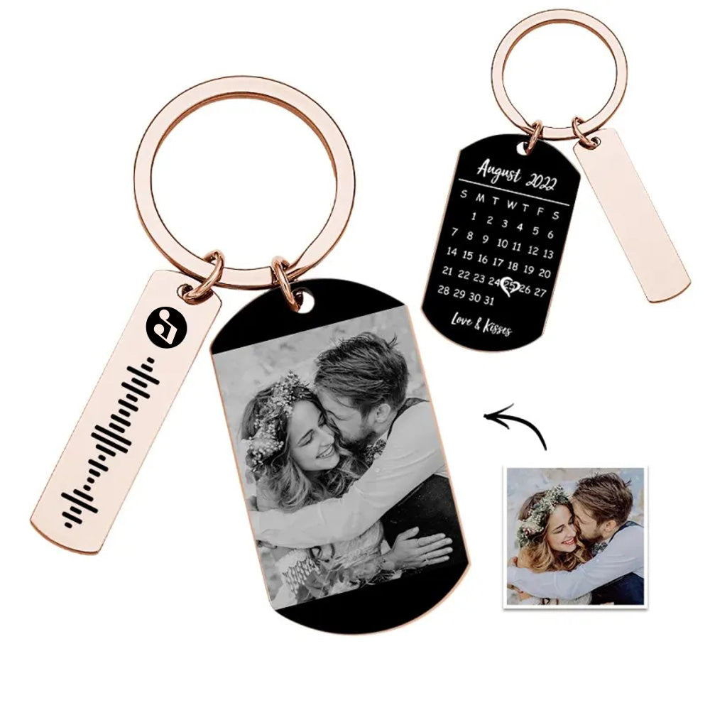 Close-up of personalised calendar tag with printed month grid, vibrant photo and scannable music code on a metal keyring