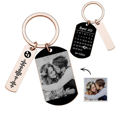 Close-up of personalised calendar tag with printed month grid, vibrant photo and scannable music code on a metal keyring