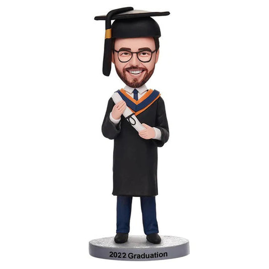 Personalised graduation man bobblehead in gown and mortarboard holding diploma with engraved base, custom polymer clay bobblehead bespoke graduation keepsake