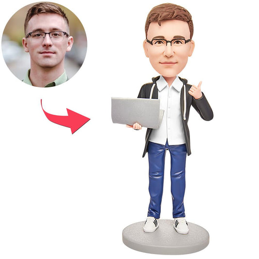 Front view of personalised male software engineer bobblehead at a computer, custom head hand-sculpted from photos in durable polymer clay with optional engraved base text