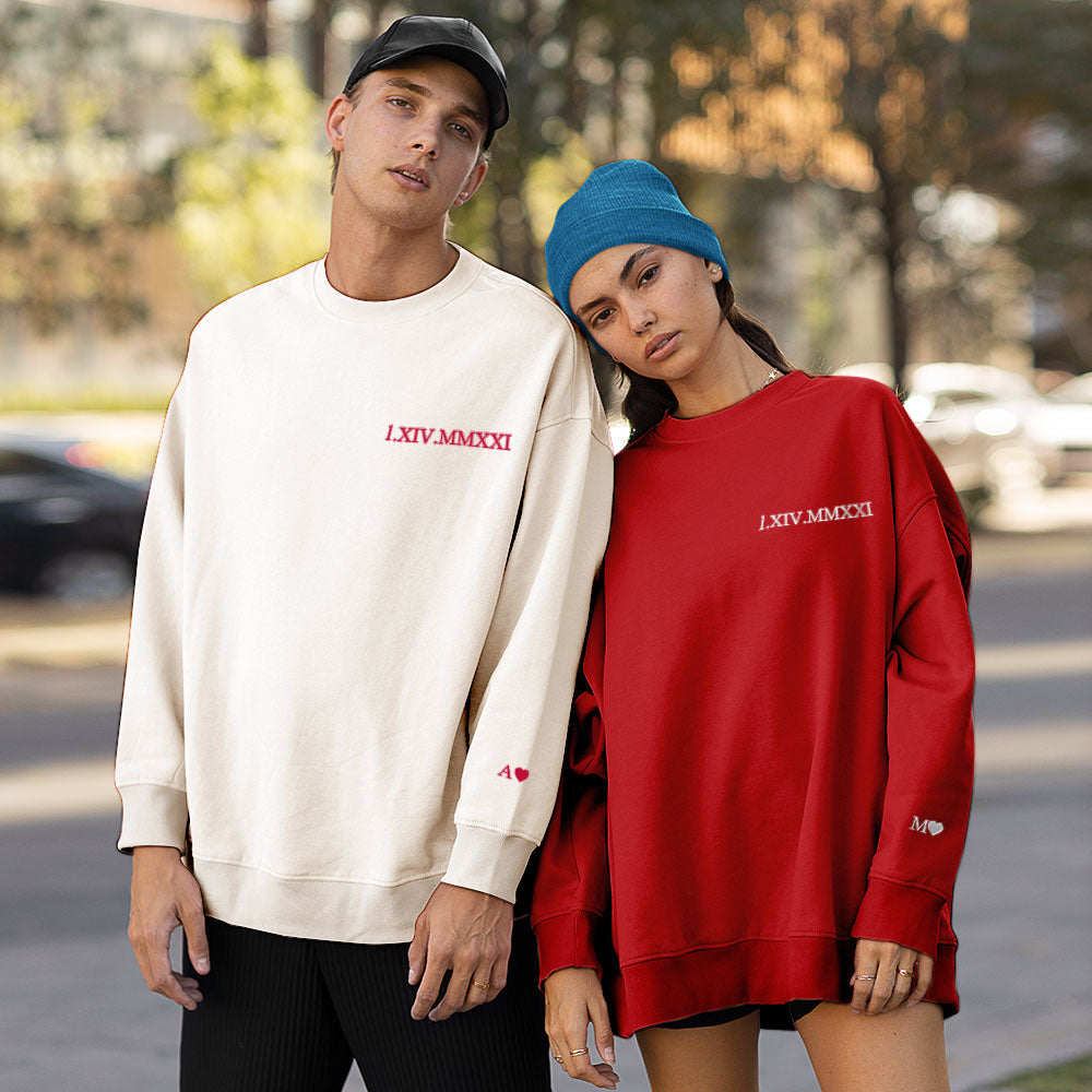 Casual couple photoshoot wearing matching personalised hoodies embroidered with a Roman numeral anniversary date