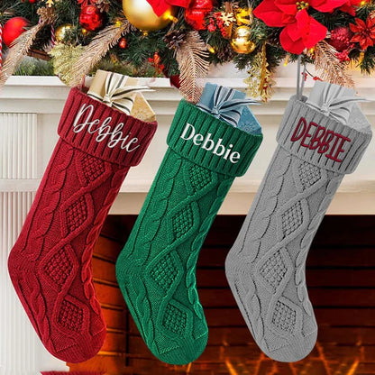 Close-up of personalised cuff on 18in knitted Christmas stocking showing embroidered custom name and soft acrylic knit texture