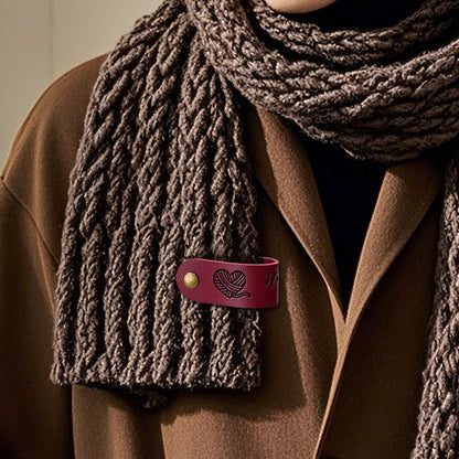 Close-up of custom PVC label sewn onto a jumper, personalised brand tag