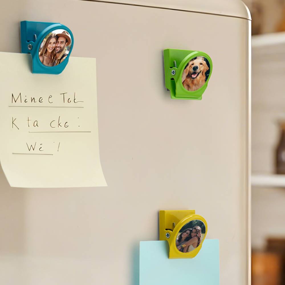 Valentine’s Day personalised magnetic clips with couple images arranged on a fridge to create a romantic photo display