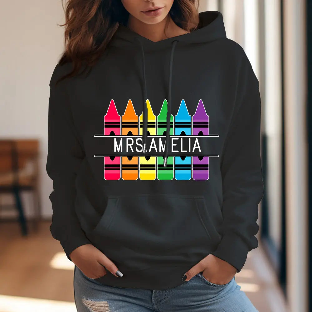 Personalised Crayon Hooded Sweatshirt front view with custom name — colourful crayon graphic, perfect teacher gift and back-to-school present
