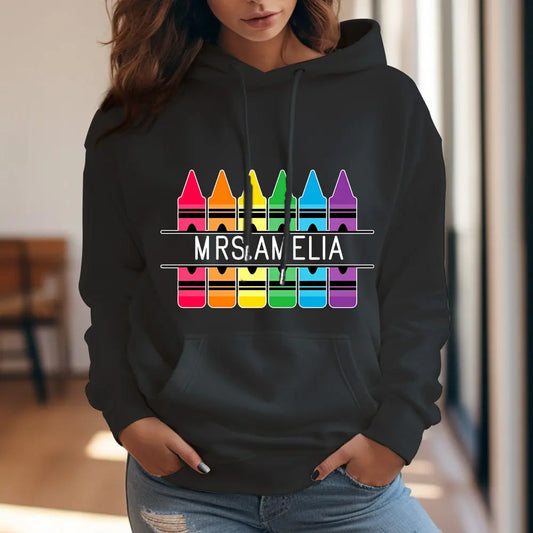 Personalised Crayon Hooded Sweatshirt front view with custom name — colourful crayon graphic, perfect teacher gift and back-to-school present