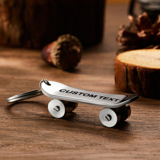Personalised skateboard keyring close-up — custom engraved stainless steel mini skate deck keychain with realistic deck and wheel detail, ideal for skaters and skateboard lovers