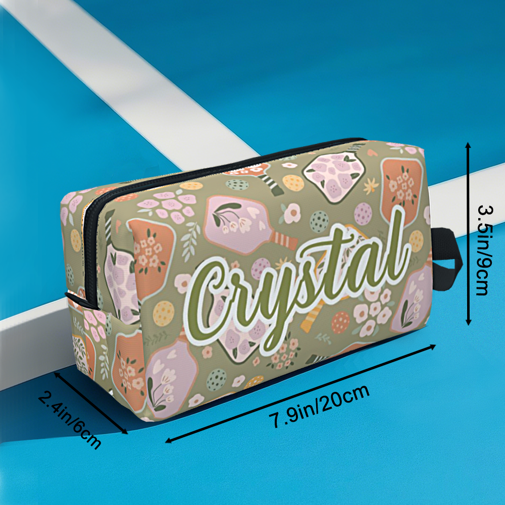 Retro flower pickleball ball pouch clipped to a sports bag with carabiner for quick access on the court