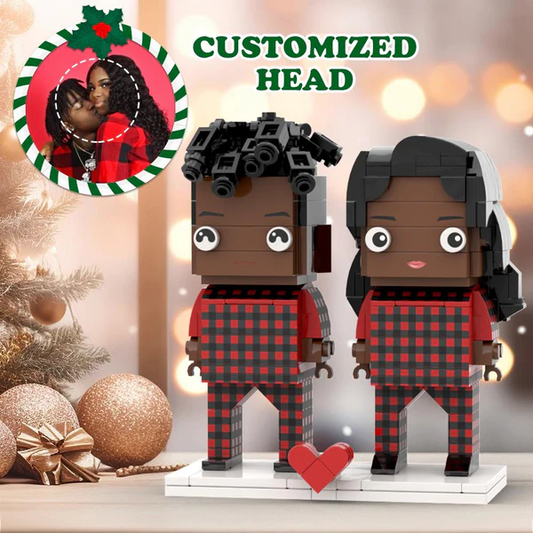 Pair of personalised Christmas brick figures of a Black couple wearing matching festive pyjamas – custom face miniatures, ideal personalised couple gift