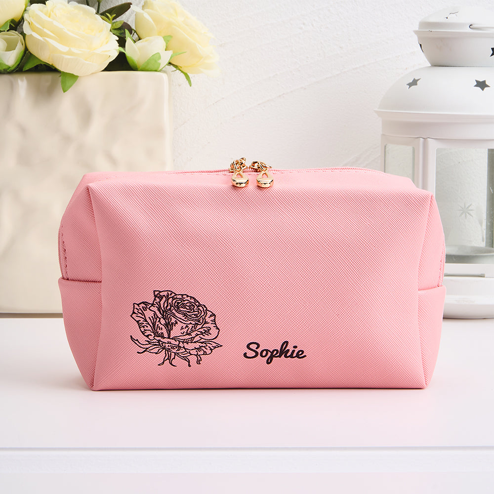 Flat-lay of personalised make-up bag with custom name and birth flower design — a thoughtful bridesmaid or Mother's Day gift