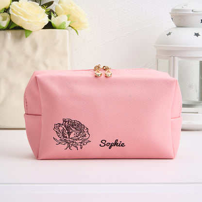 Flat-lay of personalised make-up bag with custom name and birth flower design — a thoughtful bridesmaid or Mother's Day gift