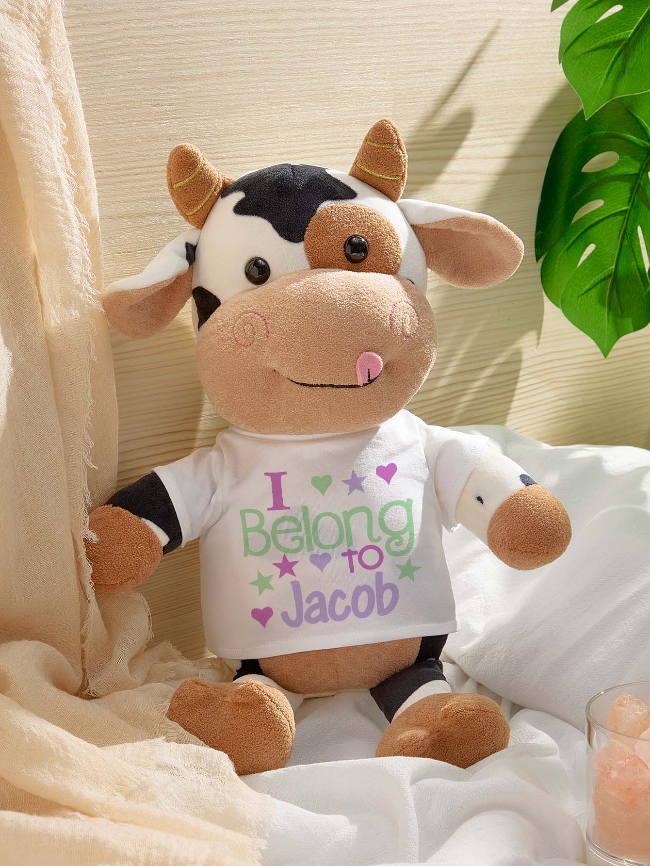 Close-up of embroidered name on the name patch of a personalised cow plush toy — high-quality stitching and custom text for a keepsake