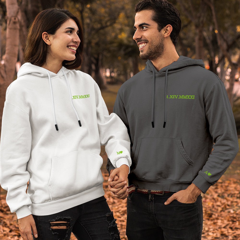 Styled flat lay of personalised embroidered hoodie — Roman numerals and name customisation, ideal gift idea