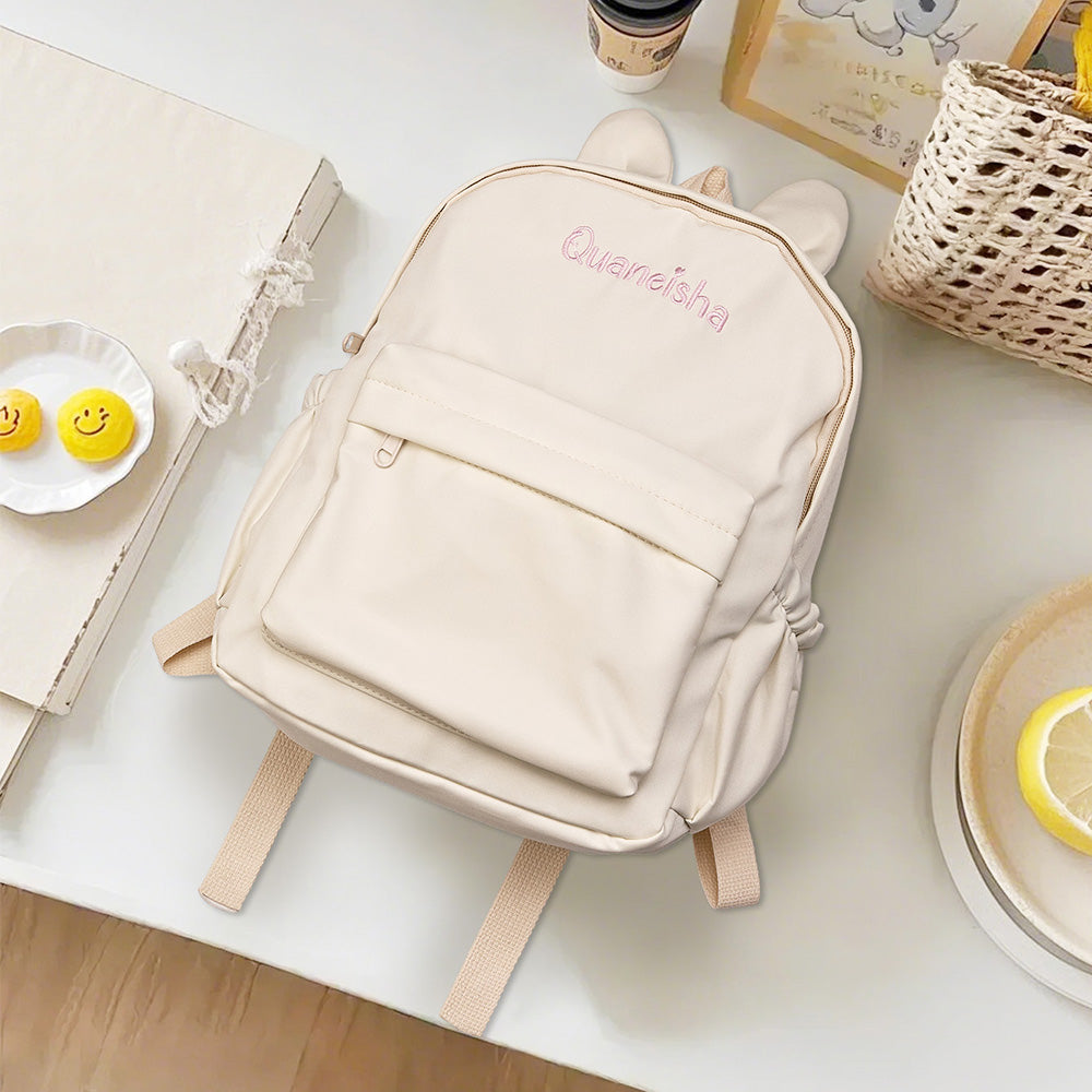 Close-up of cute rabbit ear detail and neat personalised name embroidery on the embroidered kids backpack