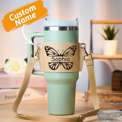 Personalised butterfly PU leather water bottle carrier bag holding a 40oz Stanley tumbler with adjustable cross‑body strap, hands‑free design
