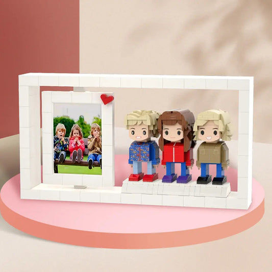 Custom Brick Figures Photo Frame featuring personalised family portraits recreated as colourful brick figures, displaying up to three miniature people in a frame as a unique family gift.