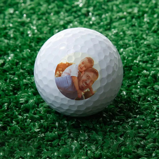 Personalised golf ball with photo printed on white dimpled surface – custom gift for golf lovers
