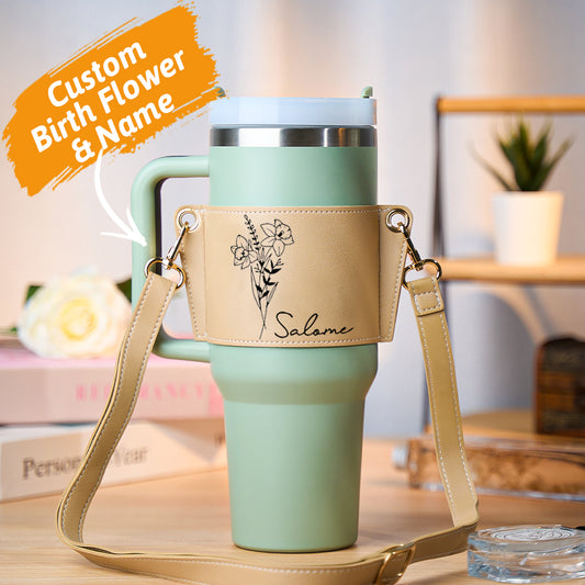 Personalised birth flower 40oz tumbler carrier bag in PU leather with adjustable strap, shown with a 40oz Stanley tumbler — stylish personalised gift for her