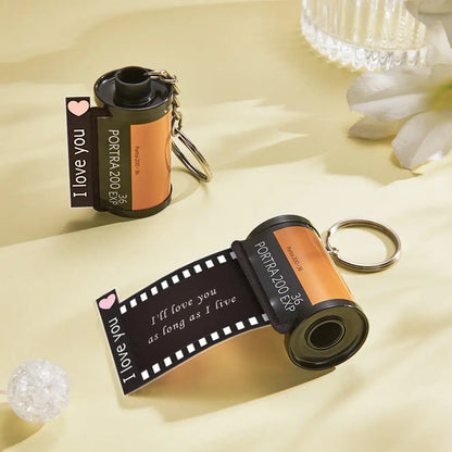 Vintage-style film reel keychain with sturdy metal loop and durable recycled-plastic reel — tested for long-lasting use