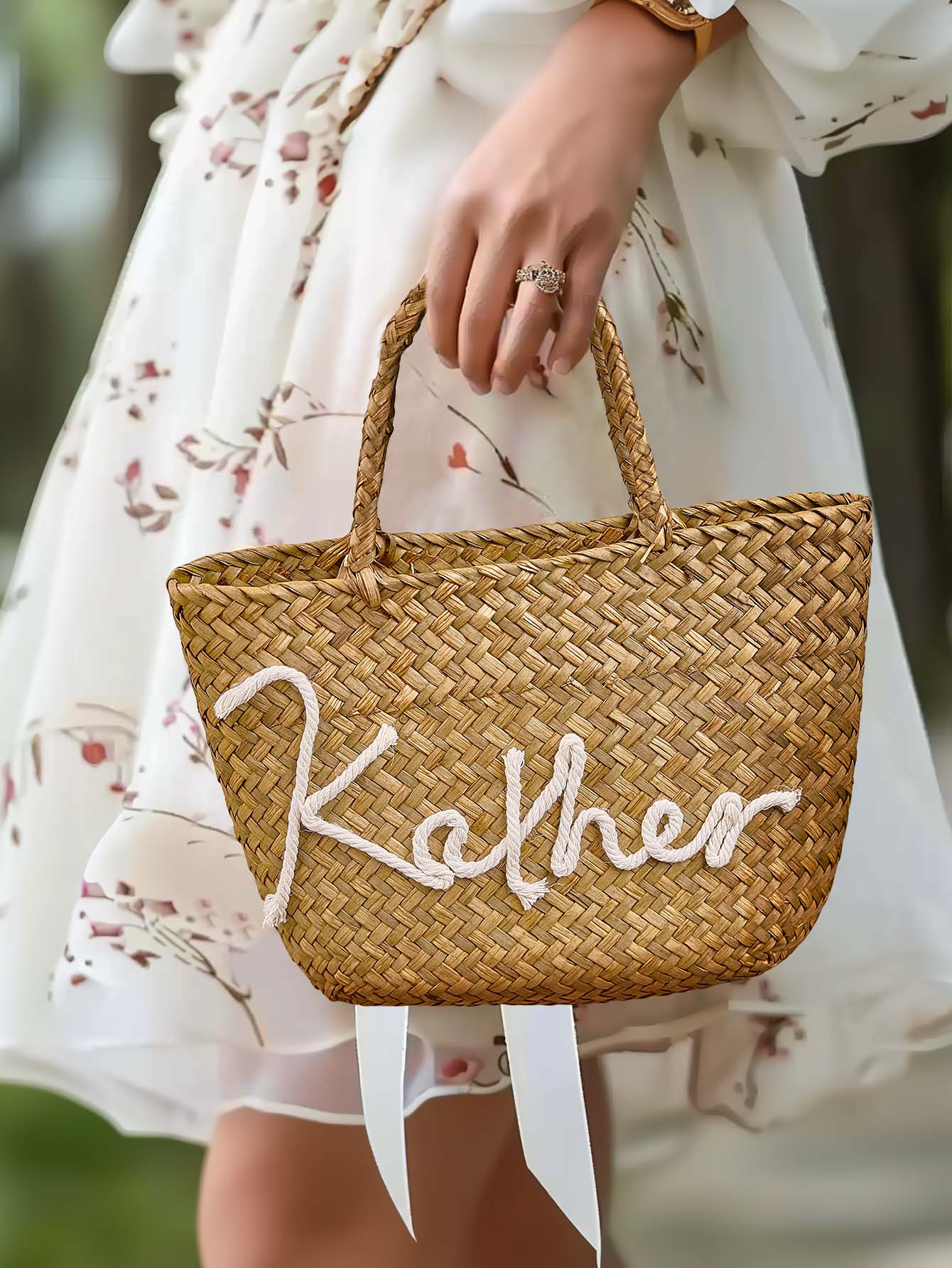 Angled shot of personalised bohemian straw bucket bag showing lightweight silhouette and handmade weave for summer holidays