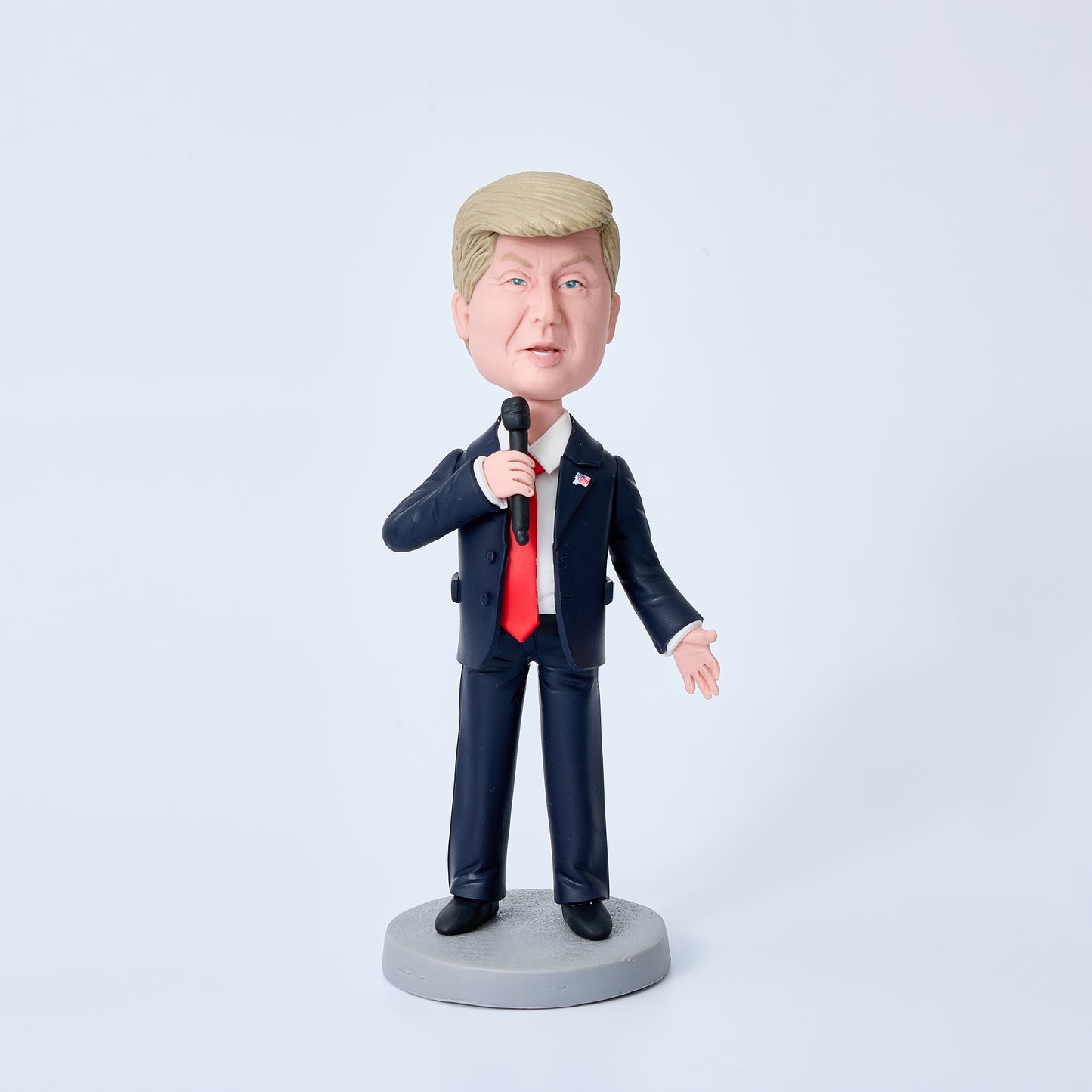 Donald Trump bobblehead in black suit holding a microphone, special edition polymer clay desk ornament and political collectable gift