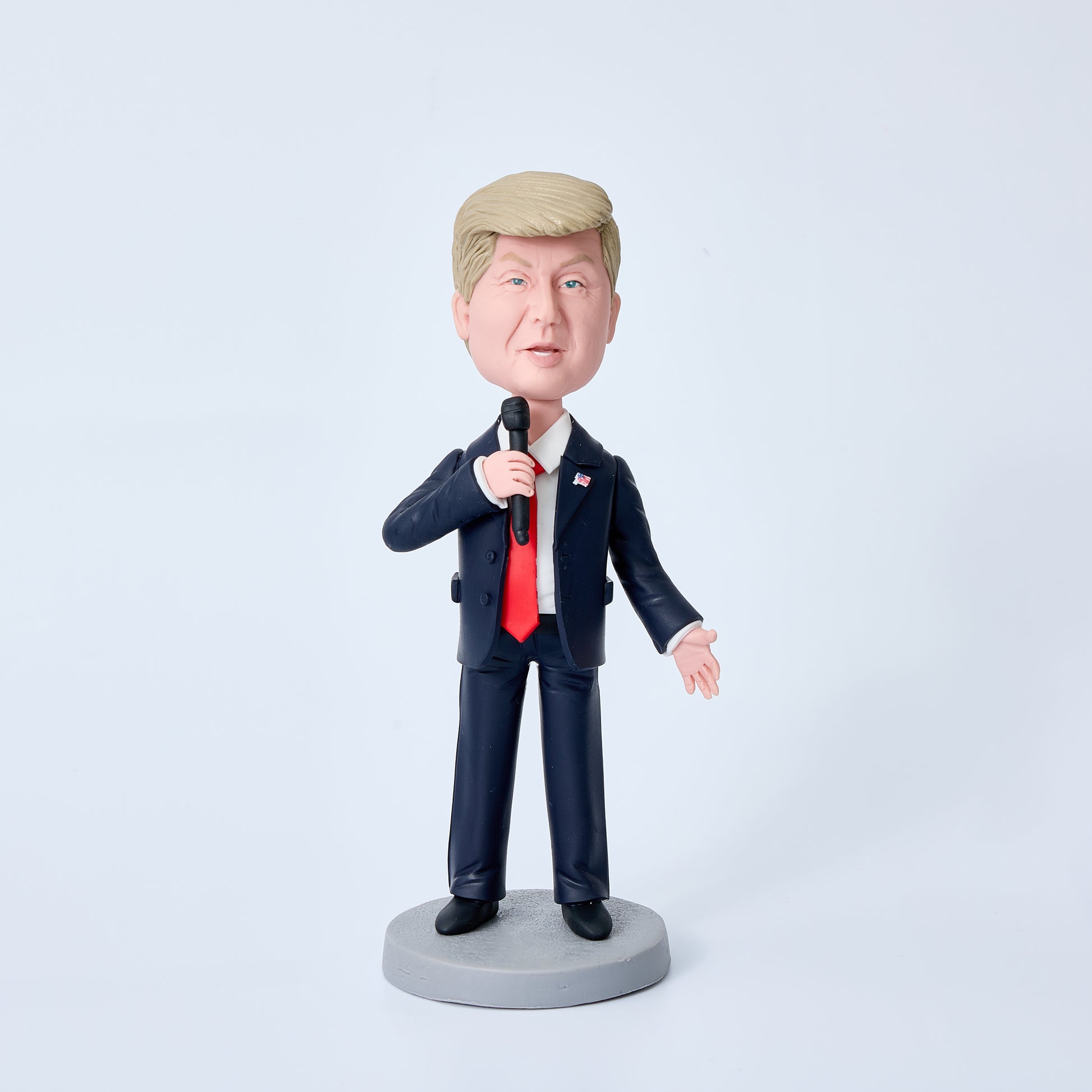 Donald Trump bobblehead in black suit holding a microphone, special edition polymer clay desk ornament and political collectable gift