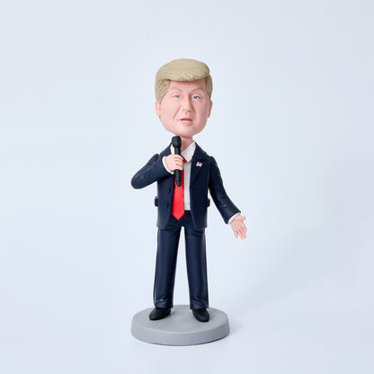 Donald Trump bobblehead in black suit holding a microphone, special edition polymer clay desk ornament and political collectable gift