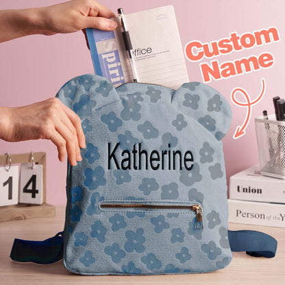 Angled shot showing personalised embroidered name, floral motif and durable zip on the mini flower canvas backpack — ideal personalised school bag for children