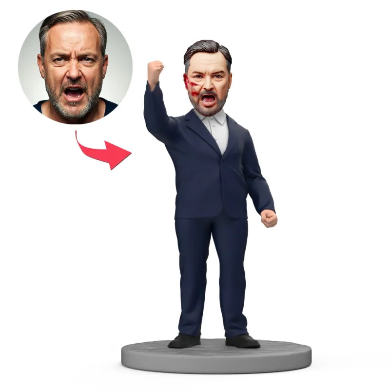 Custom face bobblehead Australia – personalised hero bobblehead in black suit with raised fist, hand‑modelled polymer clay mini‑me with engraved text