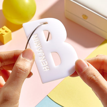 Easy-care personalised acrylic name tag being wiped clean with a soft damp cloth to preserve print quality and colourfastness