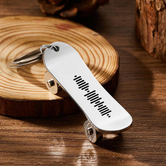 Personalised scannable music code skateboard keyring — polished stainless steel close-up showing laser-engraved music code and custom text, ideal custom skateboard keychain gift for music lovers