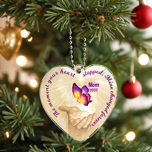 Close-up of the laser-engraved butterfly and name on a clear acrylic car charm.