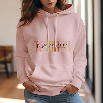 Teacher wearing personalised hooded sweatshirt showing back custom name — perfect end-of-year or Christmas gift for school staff and tutors