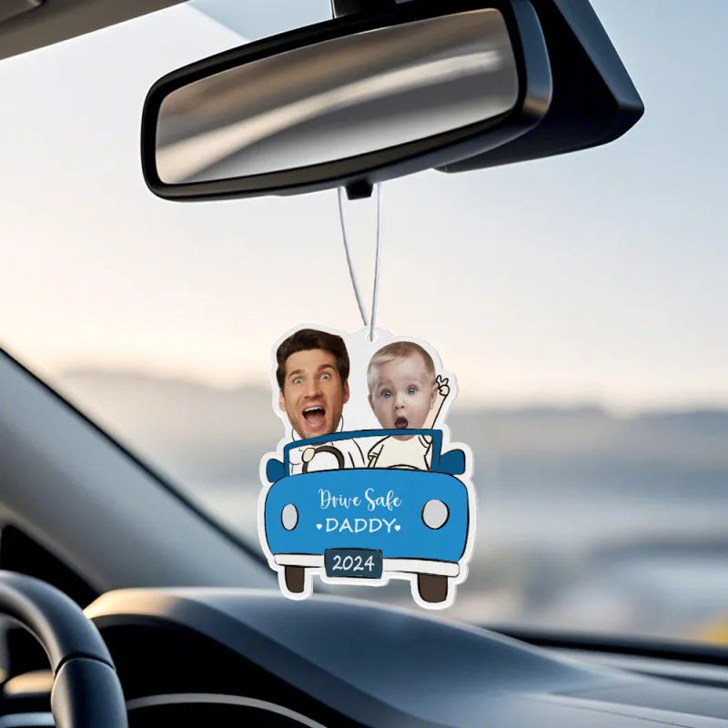 Air freshener hanging from a car rear-view mirror, showing its ornament-like design.