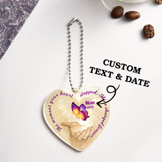 Clear acrylic butterfly car ornament with a personalised name and heart engraving, a memorial rear-view mirror keepsake.